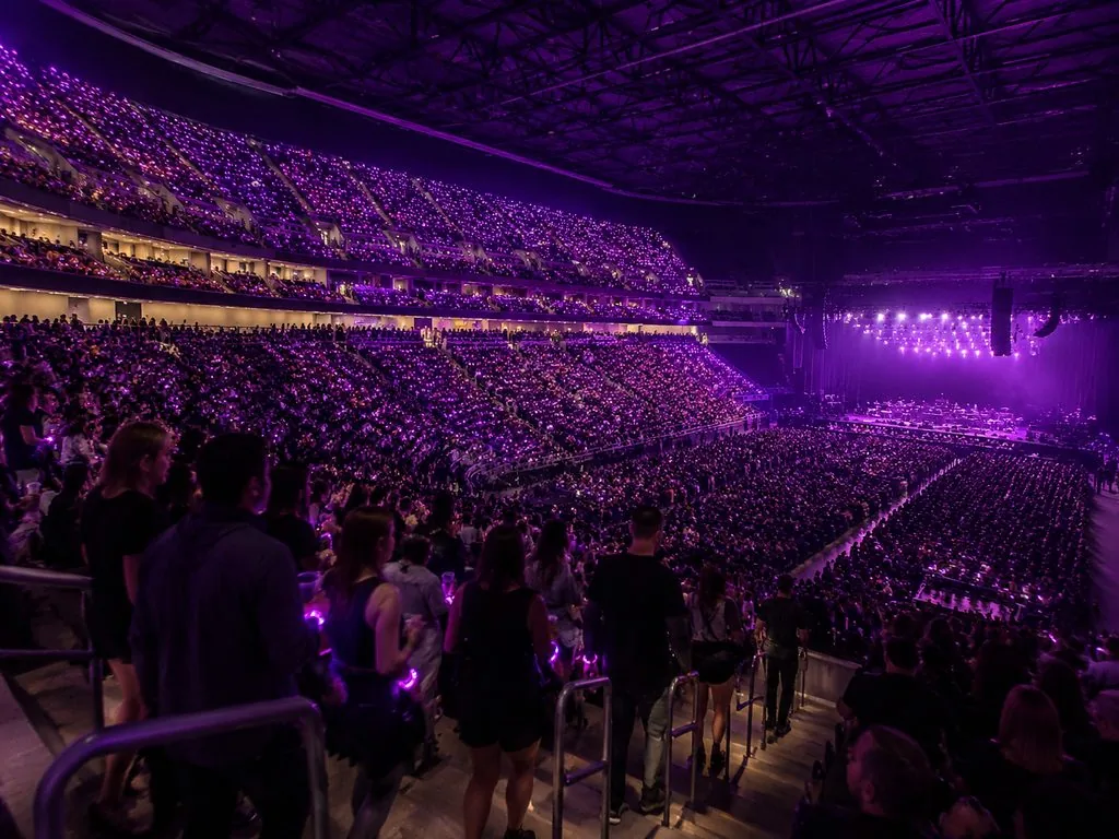 Arena bowl glowing violet as fans find their seats