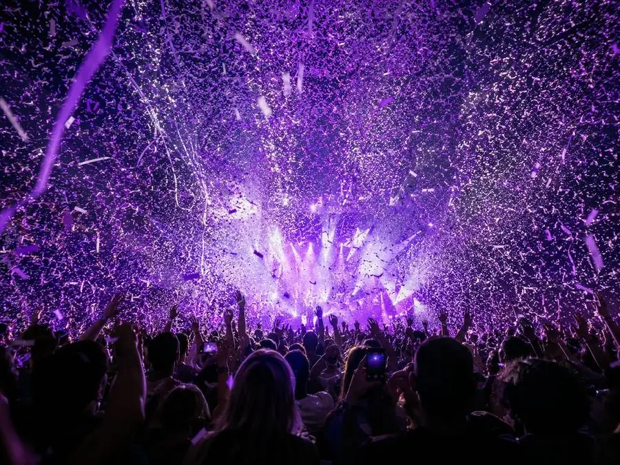 Confetti falling over the arena crowd at the finale