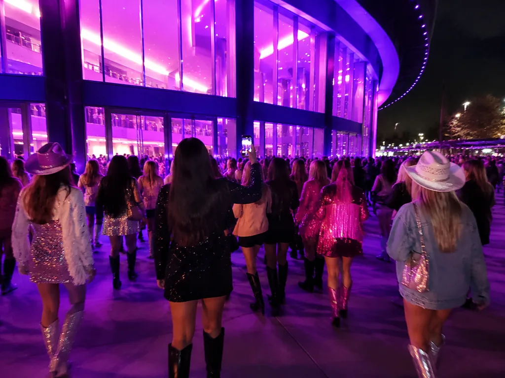 Fans arriving at the glowing arena entrance on show night